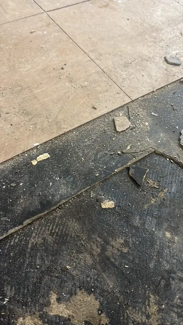Black bitumen mastic floor removal in a NW11 flat